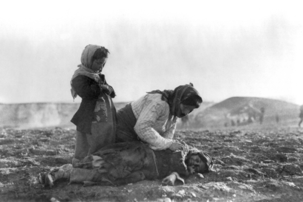 Armenian women kneels beside dead child during the Armenian Genocide
